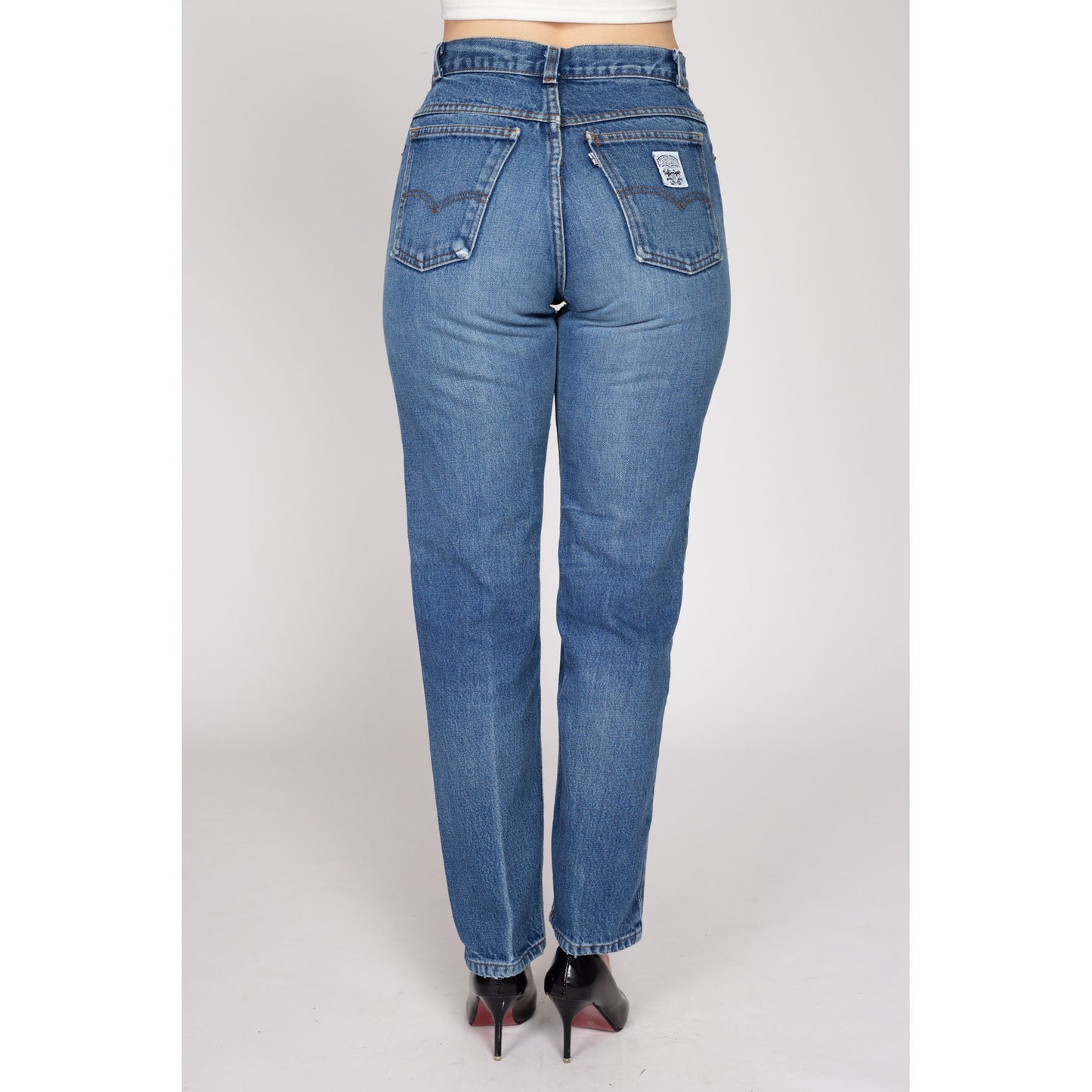 Medium 80s Levis White Tab High Waisted Jeans 28" | Vintage Levi's Medium Wash Denim Tapered Leg Mom Jeans